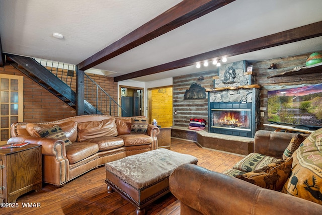 2444 S Jan Ln, Pinetop, AZ 85935 - living room with stairs, wood-type flooring, a fireplace, and beamed ceiling