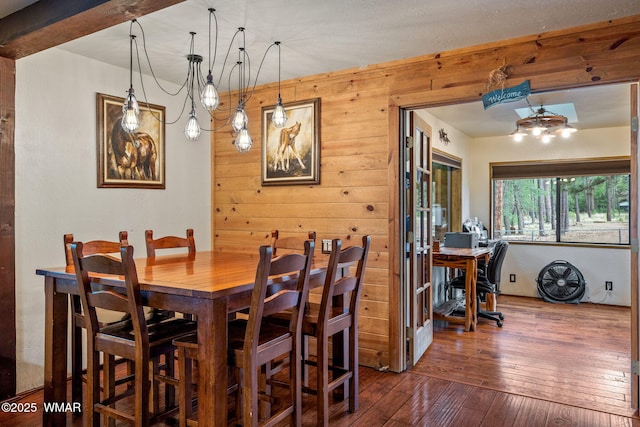 2444 S Jan Ln, Pinetop, AZ 85935 - dining area with wooden walls, dark wood-type flooring, an office area, and a chandelier