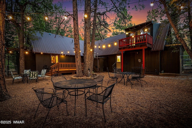 2444 S Jan Ln, Pinetop, AZ 85935 - patio terrace at dusk featuring outdoor dining space and a wooden deck