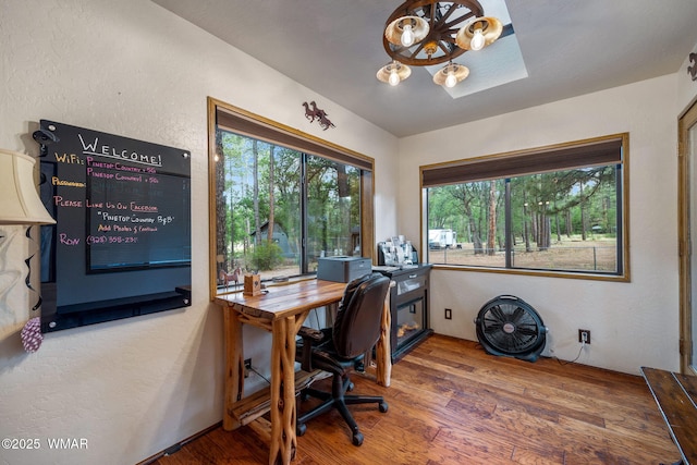 2444 S Jan Ln, Pinetop, AZ 85935 - home office featuring wood finished floors, a textured wall, and a chandelier