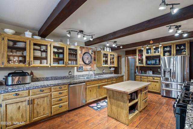 2444 S Jan Ln, Pinetop, AZ 85935 - kitchen with appliances with stainless steel finishes, beam ceiling, butcher block countertops, dark wood-type flooring, and open shelves