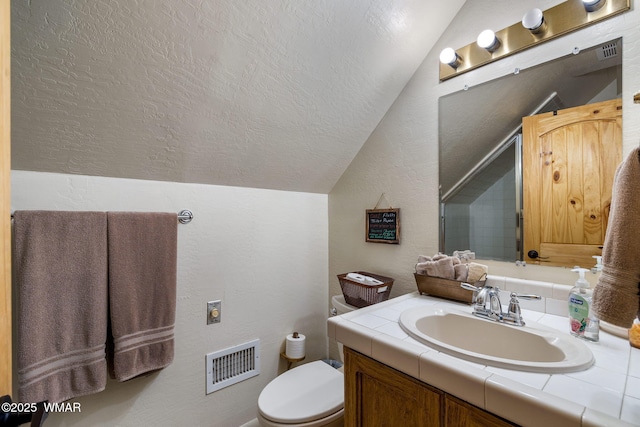 2444 S Jan Ln, Pinetop, AZ 85935 - bathroom with vaulted ceiling, vanity, a textured ceiling, and a textured wall