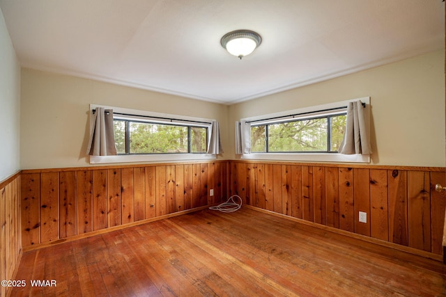 3510 Sunset Ln, Lakeside, AZ 85929 - unfurnished room with a wainscoted wall, healthy amount of natural light, wood-type flooring, and wood walls