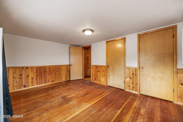 3510 Sunset Ln, Lakeside, AZ 85929 - unfurnished bedroom with hardwood / wood-style floors, wainscoting, and wood walls