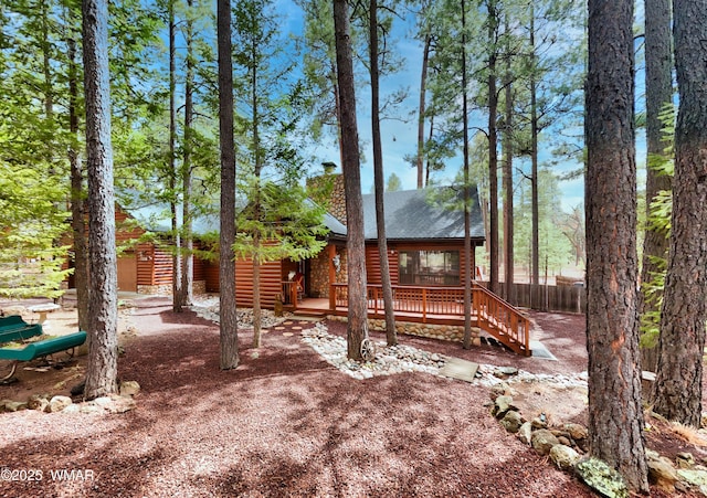 view of yard featuring fence and a wooden deck