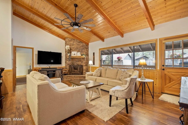 living room featuring beam ceiling, a wainscoted wall, wood ceiling, wood finished floors, and high vaulted ceiling