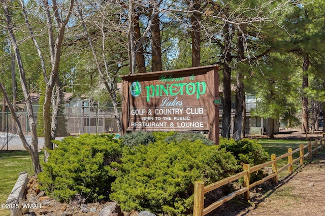 community / neighborhood sign with fence