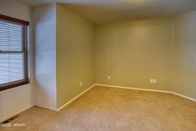 unfurnished room featuring light carpet, visible vents, and baseboards