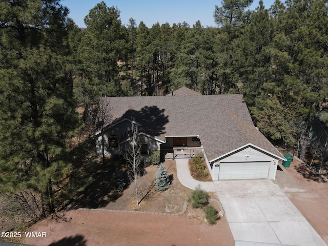 drone / aerial view featuring a view of trees