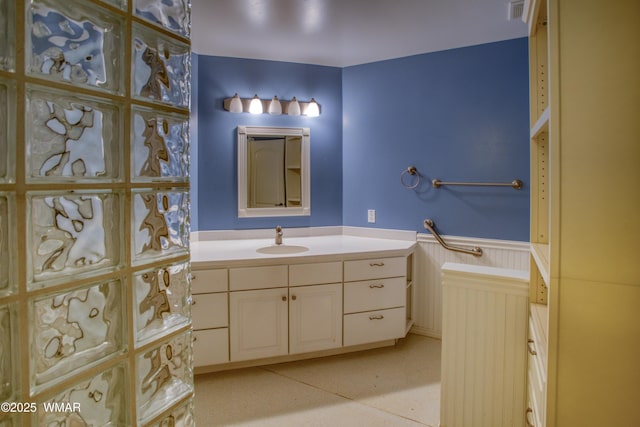 bathroom with visible vents, a wainscoted wall, and vanity