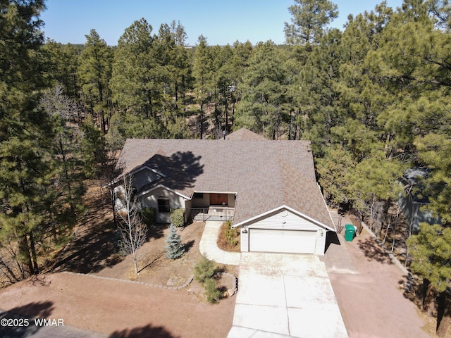 birds eye view of property with a forest view