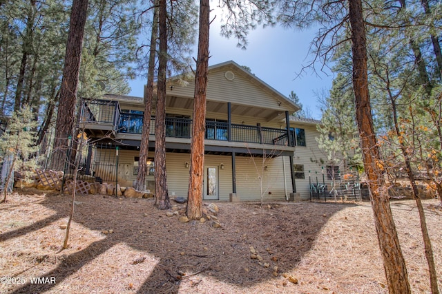 back of house with a wooden deck