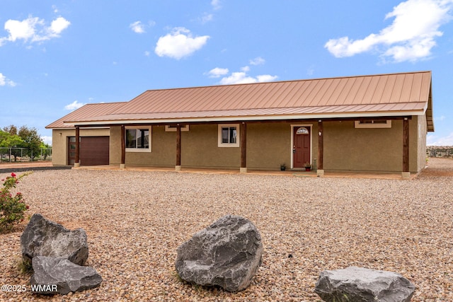2740 E Walnut Dr, Taylor, AZ 85939 - view of front of property featuring a garage, stucco siding, metal roof, and a standing seam roof