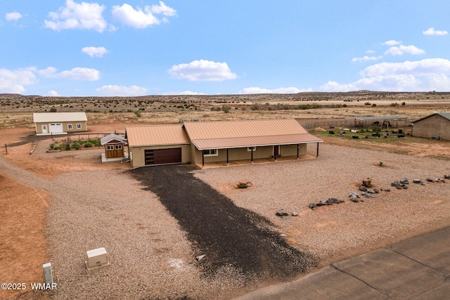 2740 E Walnut Dr, Taylor, AZ 85939 - view of front of house with an attached garage, driveway, a view of countryside, metal roof, and view of desert