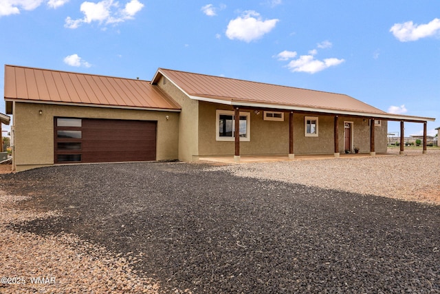 2740 E Walnut Dr, Taylor, AZ 85939 - view of front facade with stucco siding, metal roof, driveway, and an attached garage