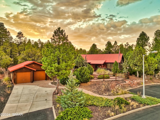 view of front of house featuring metal roof and a detached garage