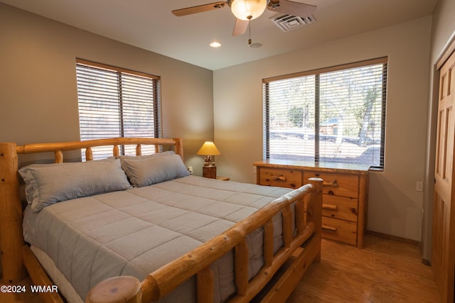 bedroom with multiple windows, recessed lighting, visible vents, and baseboards