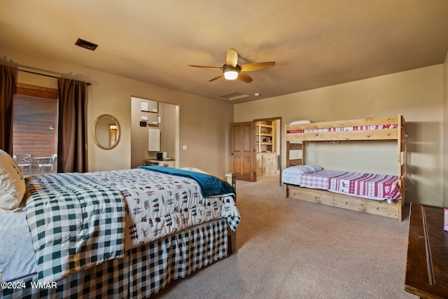 carpeted bedroom with visible vents and a ceiling fan