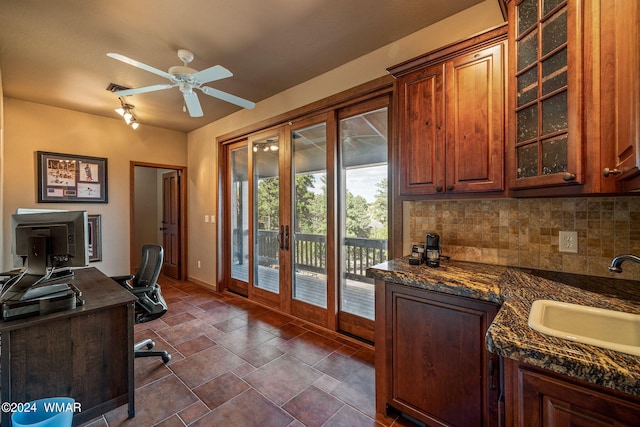 office with baseboards, a ceiling fan, stone finish flooring, french doors, and a sink
