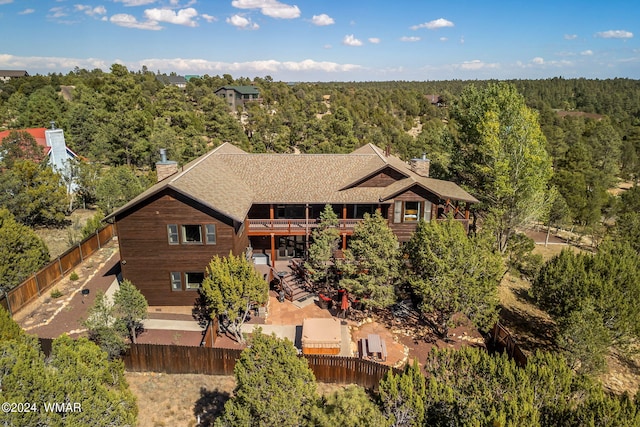 aerial view featuring a wooded view