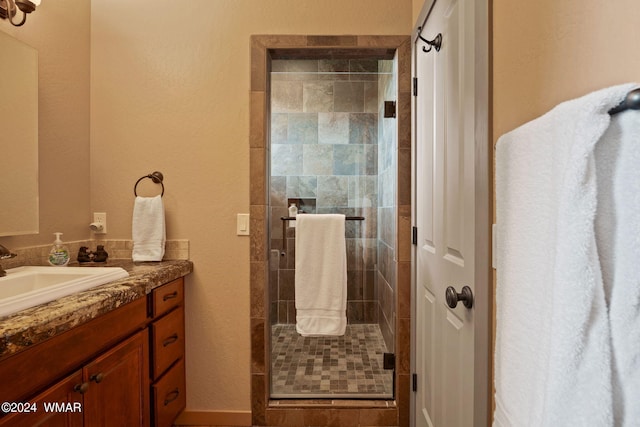bathroom featuring a shower stall and vanity