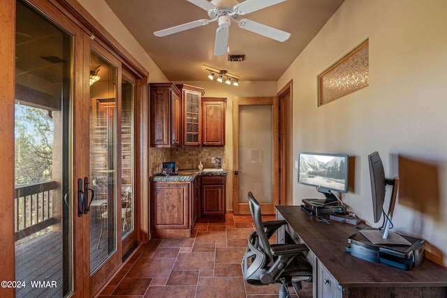 office area with stone finish flooring, visible vents, and a ceiling fan