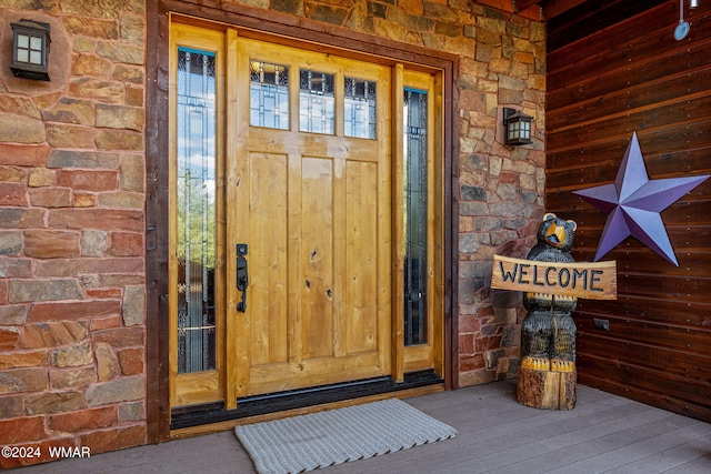 property entrance with stone siding