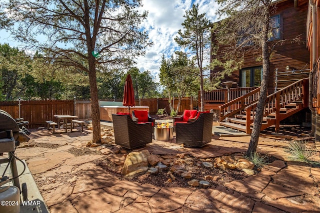 view of patio / terrace with stairway, a fenced backyard, and an outdoor living space