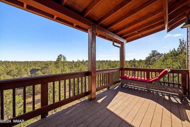 wooden deck with a view of trees