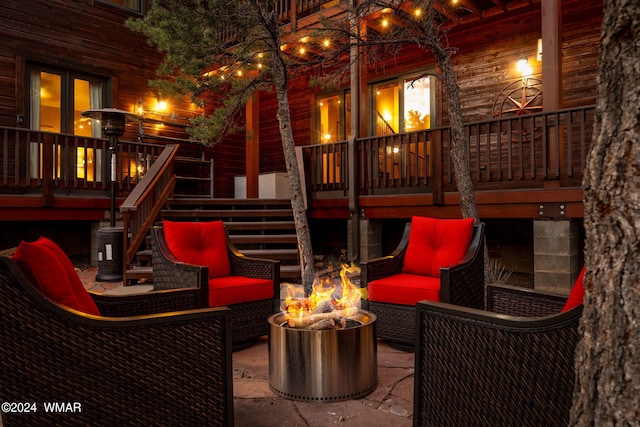 view of patio with an outdoor living space with a fire pit and stairs