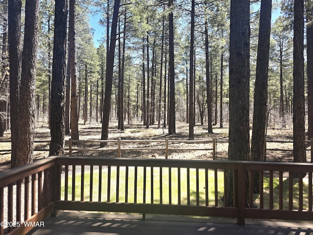 wooden deck featuring fence and a lawn