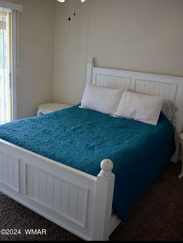 bedroom featuring dark colored carpet