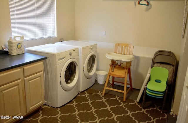 washroom featuring cabinet space and independent washer and dryer