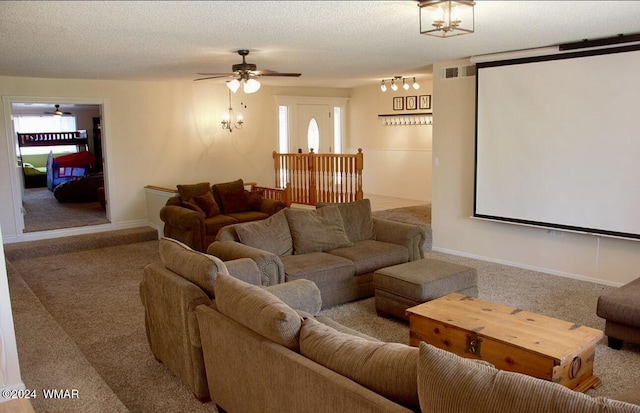 carpeted home theater room featuring a textured ceiling, plenty of natural light, and visible vents