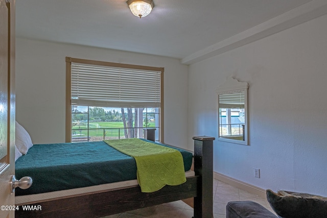 bedroom with baseboards and light tile patterned flooring