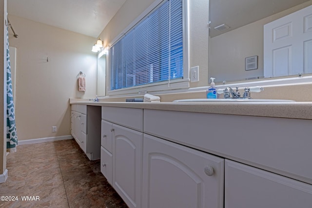 bathroom with vanity and baseboards