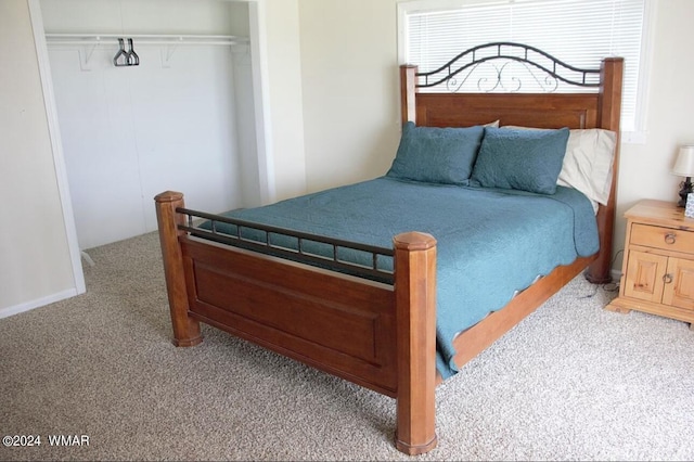 bedroom with light carpet and a closet