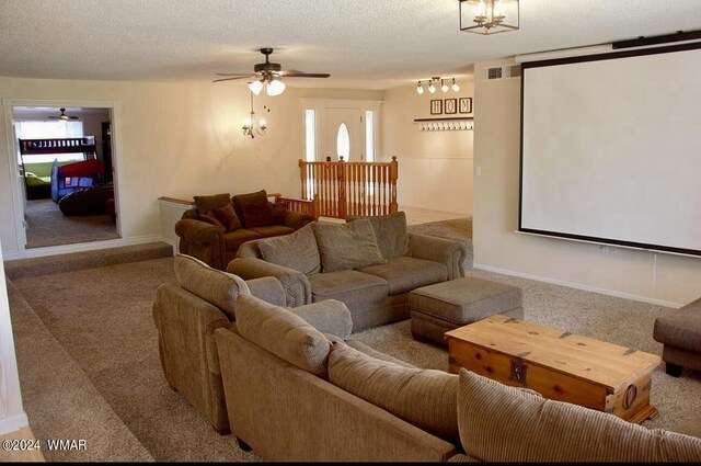 carpeted home theater room featuring a textured ceiling, ceiling fan, and baseboards