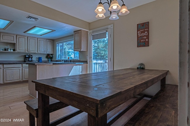 dining space featuring a chandelier, wood finished floors, and visible vents