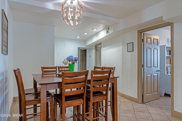 dining space featuring baseboards, a chandelier, and light tile patterned flooring