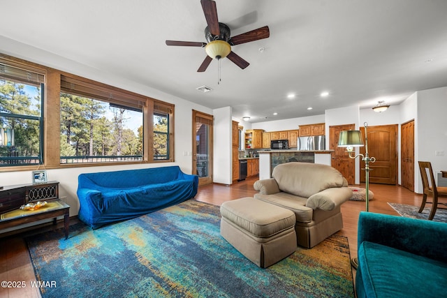 living area with recessed lighting, wood finished floors, visible vents, and ceiling fan