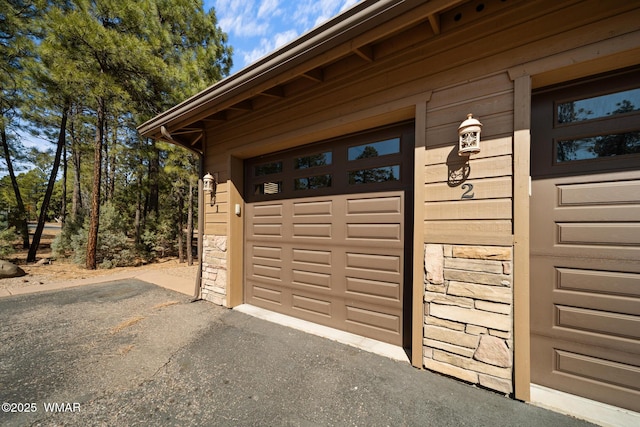 garage featuring aphalt driveway