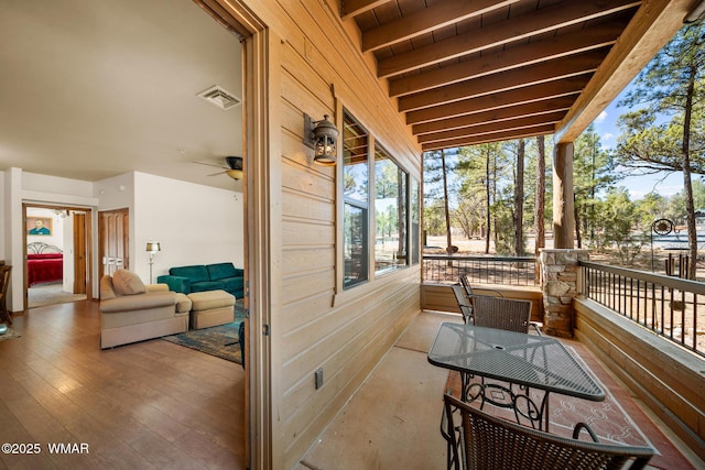 deck with visible vents and covered porch