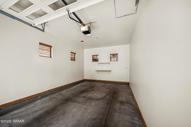 garage with a garage door opener and baseboards