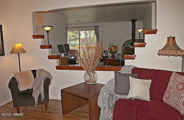 living area featuring stairs, wood finished floors, and baseboards