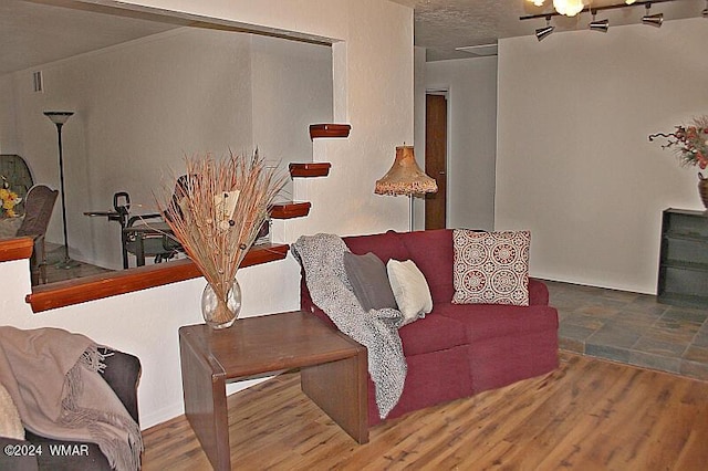 living room featuring a textured ceiling and wood finished floors