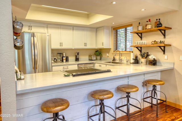 6970 Palomino Dr, Pinetop, AZ 85935 - kitchen with stainless steel appliances, white cabinetry, a sink, and a peninsula