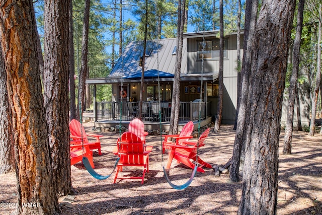 6970 Palomino Dr, Pinetop, AZ 85935 - back of property with a deck, a fire pit, and metal roof