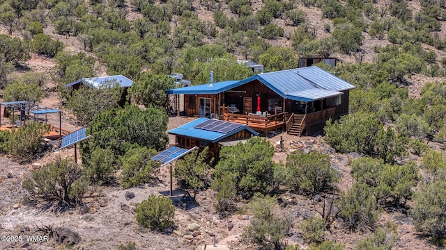 4269 Rock Rd, Snowflake, AZ 85937 - back of property with ground mounted solar panels and a wooded view