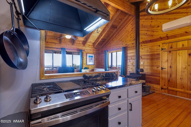 4269 Rock Rd, Snowflake, AZ 85937 - kitchen with gas stove, a wall mounted air conditioner, wood walls, wood ceiling, and hardwood / wood-style floors